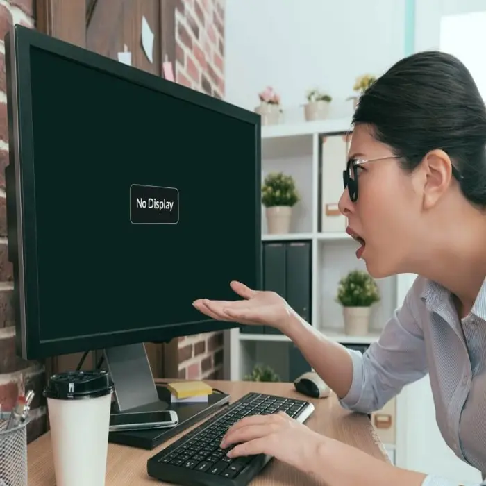A woman in front of a monitor